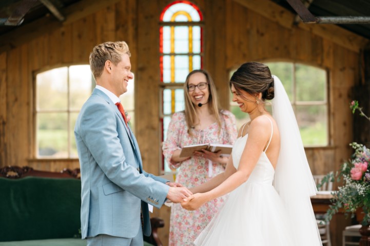 Moment of laughter at a modern rustic wedding ceremony at Oak Tree Barn, Tonbridge taken by Amy Sanders Photography and delivered by Alex Hilder - Celebrant